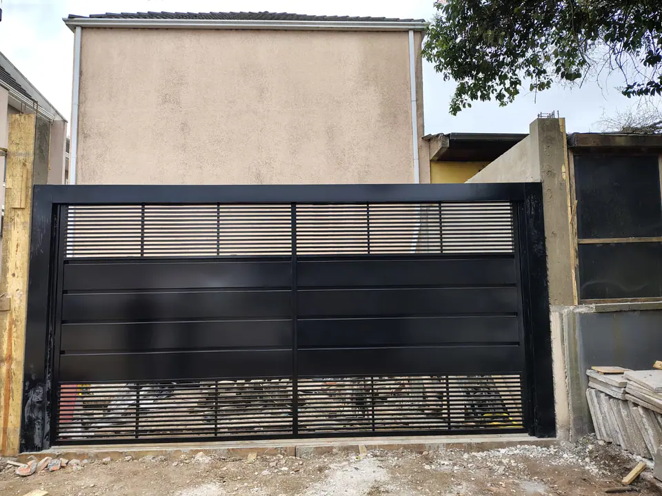 Portão de garagem preto com chapa e lâminas vazadas